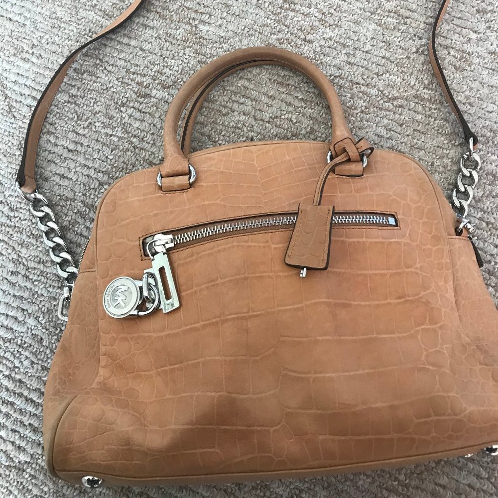 Micheal Kors med. size Handbag has crossbody strap